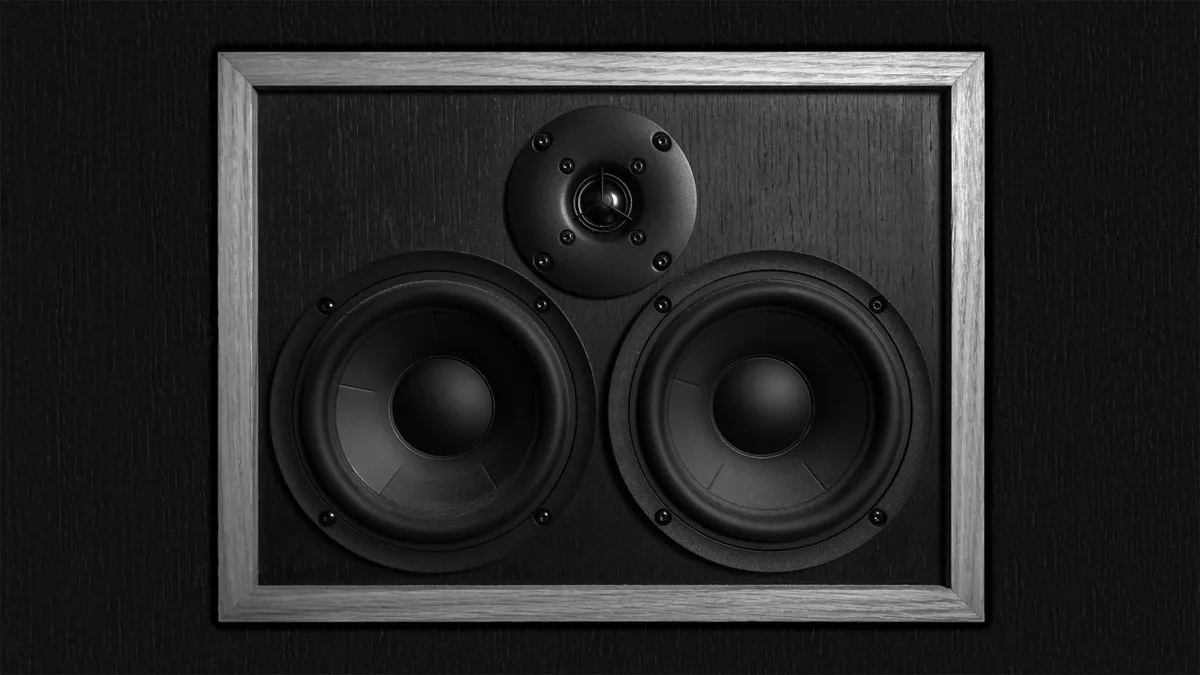 A vintage style speaker system with three drivers framed in wood set against a dark background symbolizing audio quality in viral marketing